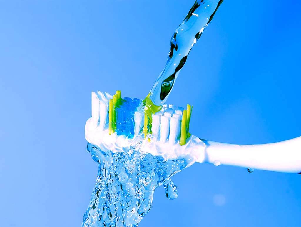 toothbrush under the running water